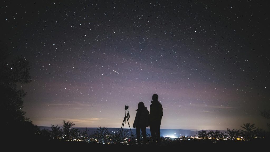 telescope buying guide. Silhouette of Two Persons Stargazing